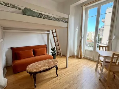 a living room with a couch and a bunk bed at Liberation Cozy Studio in Nice in Nice