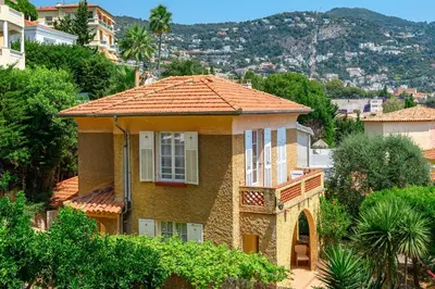 a house with an orange tile roof on a hill at Villa Mi Rancho Vue mer - Jardin - Plage et resto à 5 min in Villefranche-sur-Mer