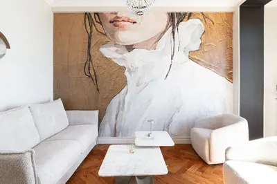 a living room with a large painting of a woman at Happyfew La Suite Del Sol in Nice