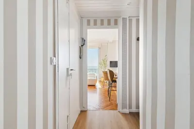a hallway with striped walls and a room with a table at Happyfew La Suite Del Sol in Nice