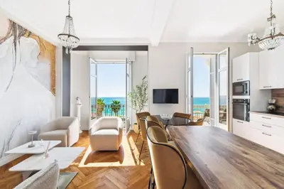 a kitchen and living room with a table and chairs at Happyfew La Suite Del Sol in Nice