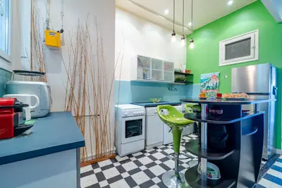 a kitchen with green walls and a checkered floor at Panoramic Sea View - Promenade des Anglais in Nice
