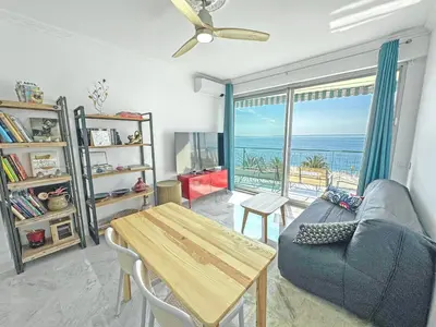 a living room with a couch and a table at Sea Front Holiday Saphir in Nice