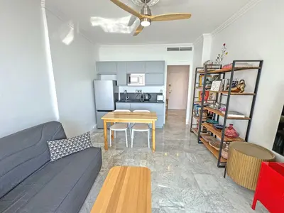a living room with a couch and a table at Sea Front Holiday Saphir in Nice