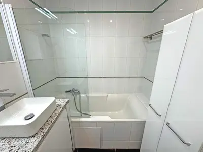 a white bathroom with a tub and a sink at Sea Front Holiday Saphir in Nice