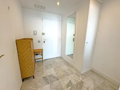 a hallway with a mirror and a dresser in a room at Sea Front Holiday Saphir in Nice