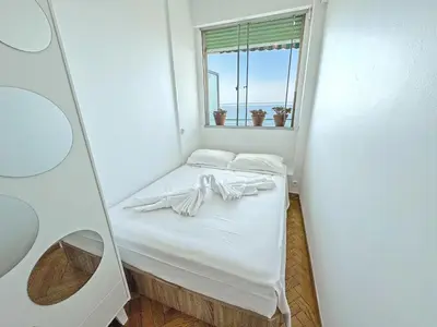 a small bed in a room with a window at Sea Front Holiday Saphir in Nice