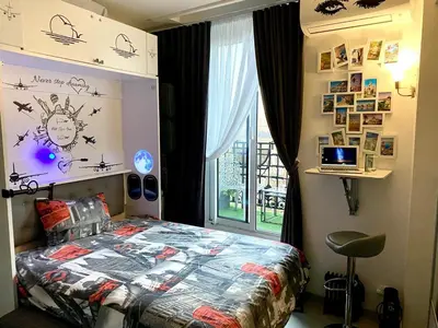 a bedroom with a bed and a window at Petit Bijou niçois in Nice