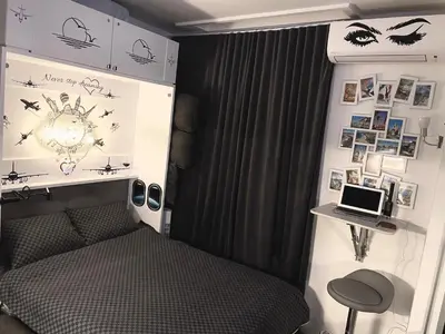 a bedroom with a bed and a laptop on a wall at Petit Bijou niçois in Nice
