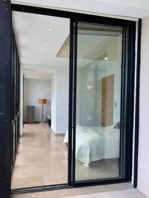 a bedroom with a glass door leading to a bed at La perle - villa de luxe in Villefranche-sur-Mer