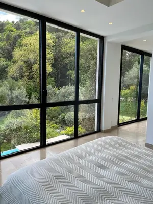 an empty room with large windows and a large rug at La perle - villa de luxe in Villefranche-sur-Mer
