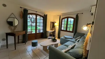 a living room with a couch and a table at Provencal Villa With Pool And Panoramic Views in La Gaude