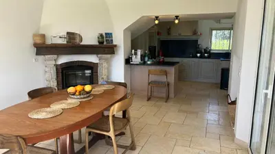 a kitchen and dining room with a table and a fireplace at Provencal Villa With Pool And Panoramic Views in La Gaude