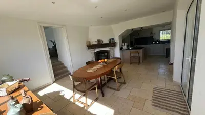 a kitchen and dining room with a wooden table at Provencal Villa With Pool And Panoramic Views in La Gaude
