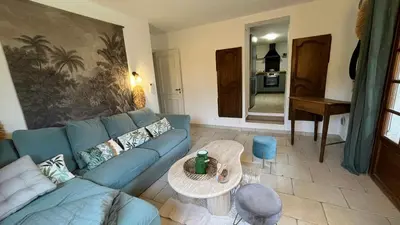 a living room with a blue couch and a table at Provencal Villa With Pool And Panoramic Views in La Gaude