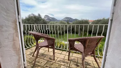 two chairs on a balcony with mountains in the background at Provencal Villa With Pool And Panoramic Views in La Gaude