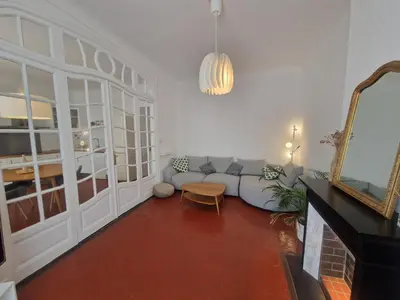 a bedroom with a bed with pillows and a window at Au Passage Niçois in Nice