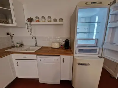 a kitchen with a refrigerator and a sink at Au Passage Niçois in Nice
