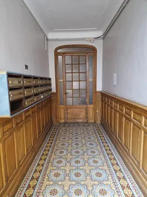 an empty room with a door and a tile floor at Au Passage Niçois in Nice