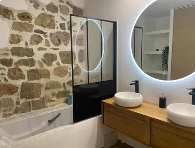a bathroom with two sinks and a mirror at Au Passage Niçois in Nice