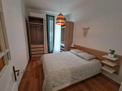 a living room with a couch and a mirror at Au Passage Niçois in Nice