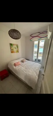 a bedroom with a white bed and a window at Two bedroom Apartment to rent in Nice in Nice
