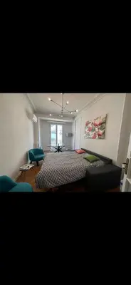 a bedroom with a bed and two blue chairs at Two bedroom Apartment to rent in Nice in Nice
