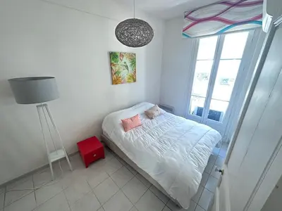 a small bedroom with a bed and a window at Two bedroom Apartment to rent in Nice in Nice