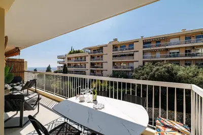 a balcony with a table with a surfboard on it at MY CASA - GAIRAUT - 5 rooms - Terrasse in Nice