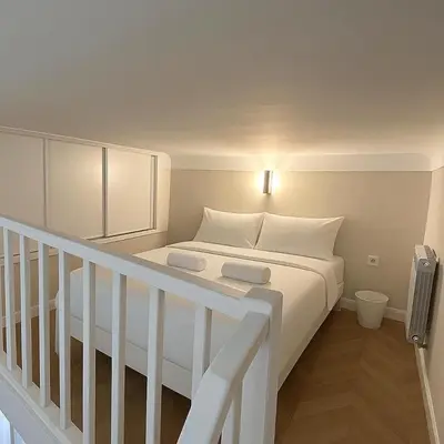 a white bed with white pillows in a room at Sea Side, Modern, Nice Promenade in Nice