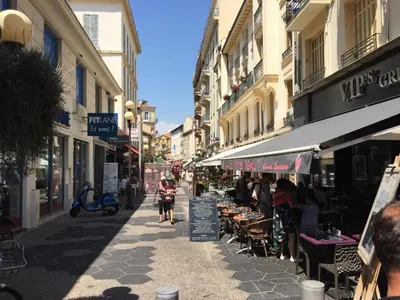 a street with people walking down a street with buildings at Sea Side, Modern, Nice Promenade in Nice