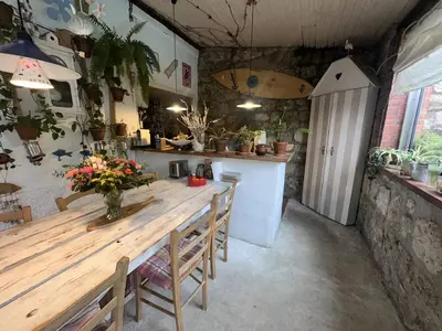a dining room with a wooden table and some plants at Nice Signature Baracca in Nice