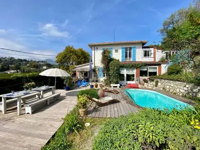 a home with a swimming pool and a house at Nice Signature Baracca in Nice