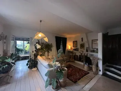 a living room with a couch and lots of plants at Nice Signature Baracca in Nice
