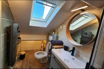 a small bathroom with a sink and a mirror at MY CASA - GRIMALDI - Sous les toits de Nice in Nice