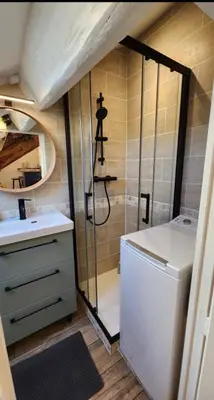 a bathroom with a shower and a washer and dryer at MY CASA - GRIMALDI - Sous les toits de Nice in Nice