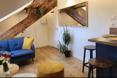a living room with a blue couch and a table at MY CASA - GRIMALDI - Sous les toits de Nice in Nice