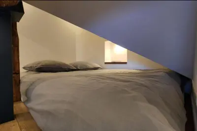 a bedroom with a bed with a geometric headboard at MY CASA - GRIMALDI - Sous les toits de Nice in Nice