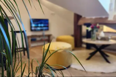 a living room with a chair and a table at MY CASA - GRIMALDI - Sous les toits de Nice in Nice
