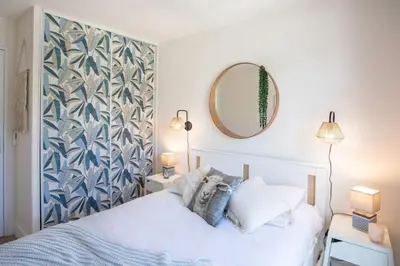 a bedroom with a white bed and a mirror at #46 Terrace AC 4mins walk Sea Tram T2 Airport Port in Nice