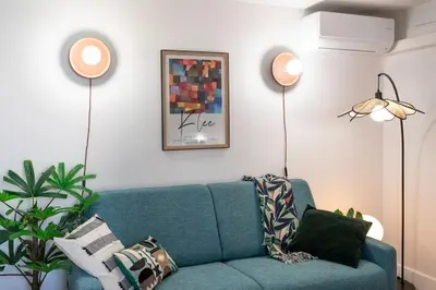 a living room with a blue couch and two lamps at #46 Terrace AC 4mins walk Sea Tram T2 Airport Port in Nice