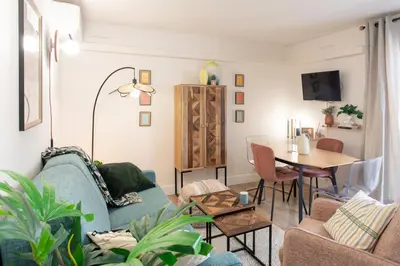 a living room with a blue couch and a table at #46 Terrace AC 4mins walk Sea Tram T2 Airport Port in Nice
