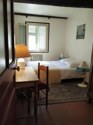 a bedroom with a bed and a table and a chair at Appartement à deux pas de la plage in Nice