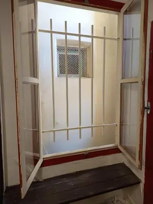 a sliding glass door with a window in a room at Appartement à deux pas de la plage in Nice