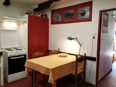 a small kitchen with a table and a stove at Appartement à deux pas de la plage in Nice