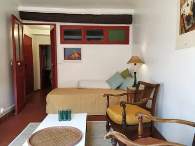 a bedroom with a bed and a table and chairs at Appartement à deux pas de la plage in Nice