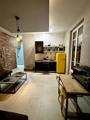 a living room with a yellow refrigerator and a kitchen at Splendide Nice Centre Clim in Nice
