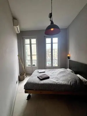 a bedroom with a bed and a large window at Splendide Nice Centre Clim in Nice