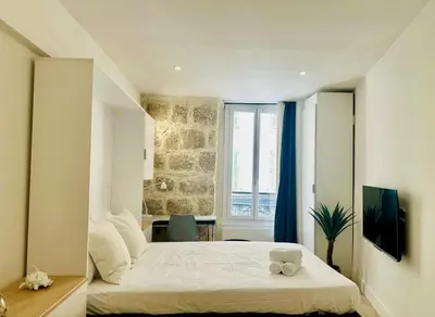 a bedroom with a bed with two cups on it at AA G Cocon Lamartine - City center in Nice