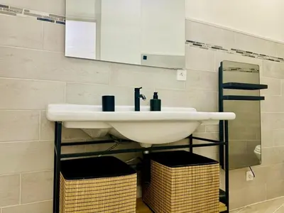 a bathroom with a sink and a mirror at AA G Cocon Lamartine - City center in Nice